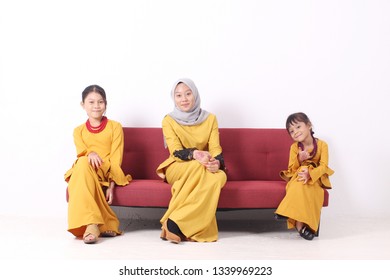 KANGAR, PERLIS, MALAYSIA,15th MARCH 2019: Asian Muslim Family Enjoying Quality Time Together With Traditional Clothes Celebrating Eid Mubarak On White Studio. Malay Family During Hari Raya Aidilfitri