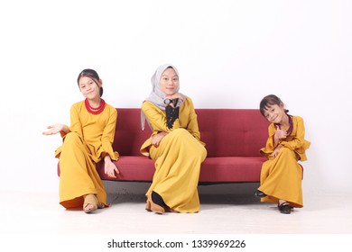 KANGAR, PERLIS, MALAYSIA,15th MARCH 2019: Asian Muslim Family Enjoying Quality Time Together With Traditional Clothes Celebrating Eid Mubarak On White Studio. Malay Family During Hari Raya Aidilfitri