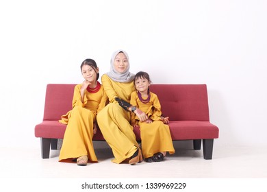 KANGAR, PERLIS, MALAYSIA,15th MARCH 2019: Asian Muslim Family Enjoying Quality Time Together With Traditional Clothes Celebrating Eid Mubarak On White Studio. Malay Family During Hari Raya Aidilfitri