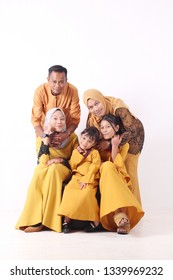 KANGAR, PERLIS, MALAYSIA,15th MARCH 2019: Asian Muslim Family Enjoying Quality Time Together With Traditional Clothes Celebrating Eid Mubarak On White Studio. Malay Family During Hari Raya Aidilfitri