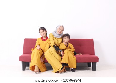 KANGAR, PERLIS, MALAYSIA,15th MARCH 2019: Asian Muslim Family Enjoying Quality Time Together With Traditional Clothes Celebrating Eid Mubarak On White Studio. Malay Family During Hari Raya Aidilfitri