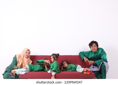 KANGAR, PERLIS, MALAYSIA,15th MARCH 2019: Asian Muslim Family Enjoying Quality Time Together With Traditional Clothes Celebrating Eid Mubarak On White Studio. Malay Family During Hari Raya Aidilfitri