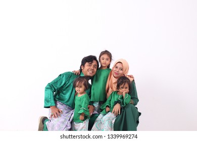 KANGAR, PERLIS, MALAYSIA,15th MARCH 2019: Asian Muslim Family Enjoying Quality Time Together With Traditional Clothes Celebrating Eid Mubarak On White Studio. Malay Family During Hari Raya Aidilfitri