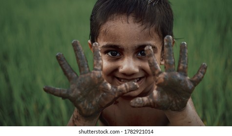 KANNUR, INDIA - July 02 : Boy With Muddy Hands.