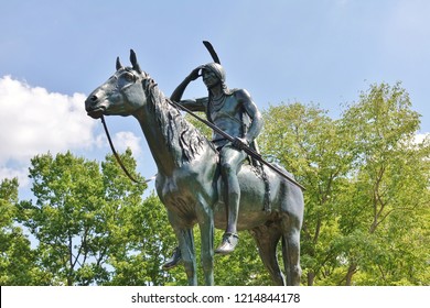 KANSAS CITY, MO -17 AUG 2018- View of the famous Scout sculpture of a Sioux Indian on horseback surveying the landscape downtown skyline of Kansas City, Missouri. 