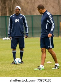 KANSAS CITY, MO - MAR 24:NFL Star Chad Ochocinco Pauses During A Drill With Teal Bunbury (r) At The Sporting KC Training Facility In Kansas City March 24, 2011