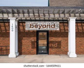 Kansas City, MO / United States Of America - February 9th, 2020 : Salon Beyond Exterior, Large Metal Cut Out Sign Above Main Entrance Door.  Aveda Salon Logo On Glass Door.