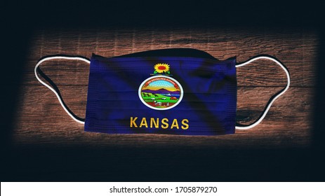 Kansas Flag. Coronavirus Covid 19 In U.S. State. Medical Mask Isolate On A Black Background. Face And Mouth Masks For Protection Against Airborne Infections In USA, America