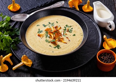 Kanttarellikeitto, Finnish Chanterelle Soup In Black Bowl On Dark Wooden Table With Spoon, Fresh Chanterelle Mushrooms On Background, Horizontal View From Above, Close-up