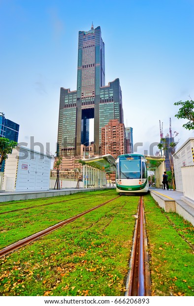 Kaohsiung, Taiwan - April 15, 2017: View of a\
light rail tram and the skyline in Kaohsiung, Taiwan on April 15,\
2017. The light rail system in Kaohsiung is the first light rail\
transit in Taiwan.