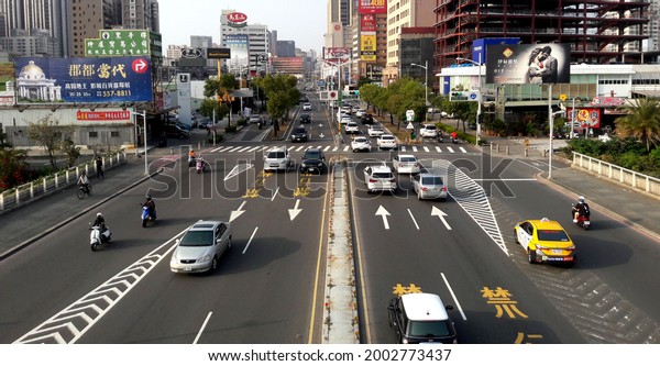 Kaohsiung, Taiwan February 25, 2020:\
Cars drive on the road. There are many bridges and sidewalks in\
Taiwan as pedestrian safety measures. Cross Bridge\
City