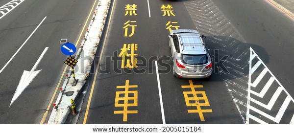 Kaohsiung, Taiwan February 25, 2020:\
Cars drive on the road. There are many bridges and sidewalks in\
Taiwan as pedestrian safety measures. Cross Bridge\
City