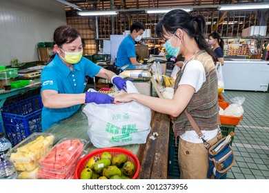 Kaohsiung, Taiwan - May 12, 2021: Female customers checkout after shopping in traditional markets