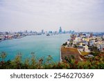 Kaohsiung, Taiwan, Republic of China, 01 25 2024: The landscape of Kaosiung port harbor, downtown, shiziwan (siziwan, xiziwan), and Qijin lighthouse