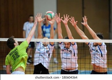 KAPOSVAR, HUNGARY - FEBRUARY 25: Unidentified players in action at a Hungarian National Championship volleyball game Kaposvar (white) vs. Sumeg (green), February 25, 2014 in Kaposvar, Hungary.