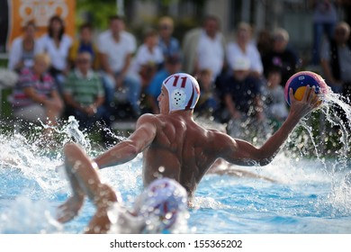 KAPOSVAR, HUNGARY - SEPTEMBER 15: Norbert Juhasz-Szelei (11) in action at a Hungarian championship water-polo game between Kaposvar (white) and Honved (blue) on September 15, 2013 in Kaposvar, Hungary