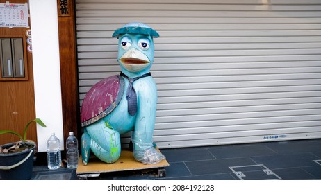 Kappabashi, Tokyo, Japan - November 27 2021: A statue of "Kappa" a mythical water imp and the official mascot of Kappabashi. Kappabashi is a street with shops dedicated to the restaurant industry. 