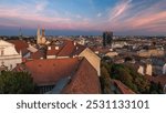 Kaptol and catholic cathedral day to night transition timelapse in the center of Zagreb, Croatia, panoramic top view of downtown from Kula Lotrscak tower after sunset