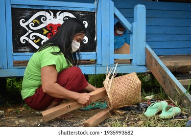 Kapuas Hulu, Indonesia - February 2nd 2021 : An Iban Woman Making Traditional Weaving