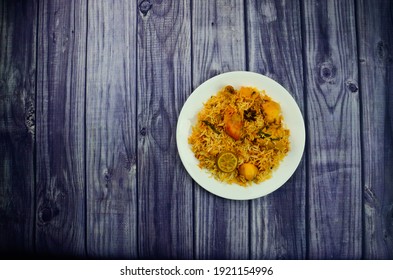 Karachi Chicken Biryani with Potatoes made in Sella rice in White Plate