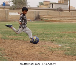 Karachi Pakistan 2019, A Kid Kicking A Football On Sunday Morning In Football Ground, Asian Kids, Local Sports, Football In Pakistan, Outdoor Activities On Weekends Morning