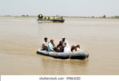 KARACHI, PAKISTAN, AUG 26: Navy (PN) rescue teams shift flood affected people towards safe place on boat and hovercraft during rescue operations at a flood affected area on August 26, 2010 in Karachi, Pakistan