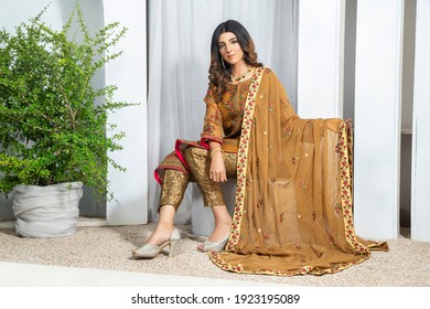 Karachi, Pakistan - February 10, 2021:Beautiful trendy woman in designer kurti dress. posing in studio. Fashion concept.