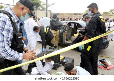 KARACHI, PAKISTAN - JUN 29: Members Of Police Crime Scene Unit Investigate Around A Car Used By Alleged Gunmen At The Main Entrance Of The Pakistan Stock Exchange Building On June 29, 2020 In Karachi.