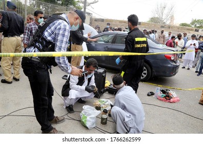 KARACHI, PAKISTAN - JUN 29: Members Of Police Crime Scene Unit Investigate Around A Car Used By Alleged Gunmen At The Main Entrance Of The Pakistan Stock Exchange Building On June 29, 2020 In Karachi.