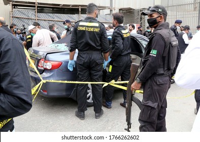 KARACHI, PAKISTAN - JUN 29: Members Of Police Crime Scene Unit Investigate Around A Car Used By Alleged Gunmen At The Main Entrance Of The Pakistan Stock Exchange Building On June 29, 2020 In Karachi.