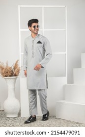 Karachi, Pakistan - May 02, 2022: Pakistani Man In Traditional Wear  Kurta Pyjama Cloths. Male Fashion Model In Sherwani, Posing In Studio, Wedding Fashion Concept