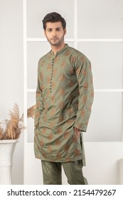 Karachi, Pakistan - May 02, 2022: Pakistani Man In Traditional Wear  Kurta Pyjama Cloths. Male Fashion Model In Sherwani, Posing In Studio, Wedding Fashion Concept