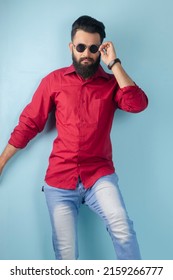 Karachi, Pakistan: May 22, 2022: Young Pakistani Man Wearing Red Shirt And Blue Jeans Designer Dress. Posing In Studio. Fashion Concept