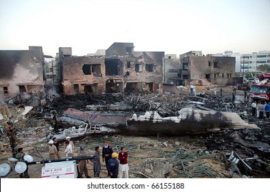 KARACHI, PAKISTAN - NOV 28: People Gather At The Site Of Plane Crash Incident On Early Morning On November 28, 2010 In Karachi.