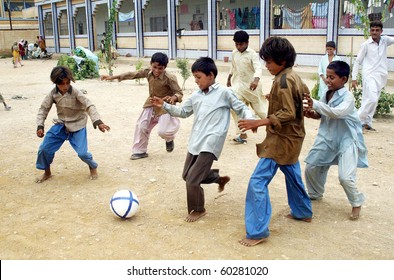 KARACHI, PAKISTAN-AUG 31: Flood affected children play with football at flood relief camp established at Razzaqabad area in Karachi on Tuesday, August 31, 2010.