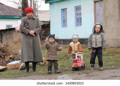 Karakol, Kyrgyzstan - March, 2019: The People Of Kyrgyzstan, Amazing Family In Front Of Their House.