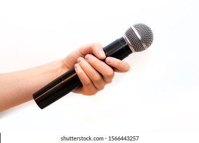Karaoke microphone in a female hand on a white background