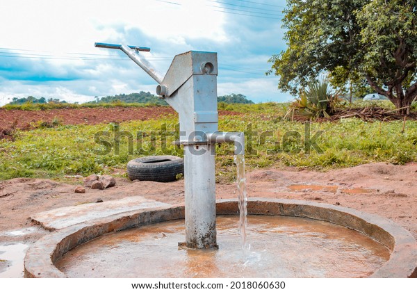 Karara, Nasarawa State - May 5, 2021: 360 Degree\
View of a Newly Constructed Indian Hand Pump Borewell in a Rural\
Community in Africa.\
Running Water from a Community Borehole Water\
Point