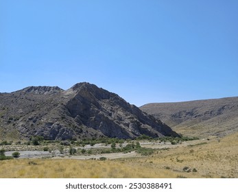 The Karatau Mountains, located in Central Asia, stretch across southern Kazakhstan and parts of Uzbekistan. These mountains are characterized by rugged terrain, steep cliffs, and diverse ecosystems, r - Powered by Shutterstock