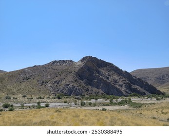 The Karatau Mountains, located in Central Asia, stretch across southern Kazakhstan and parts of Uzbekistan. These mountains are characterized by rugged terrain, steep cliffs, and diverse ecosystems, r - Powered by Shutterstock