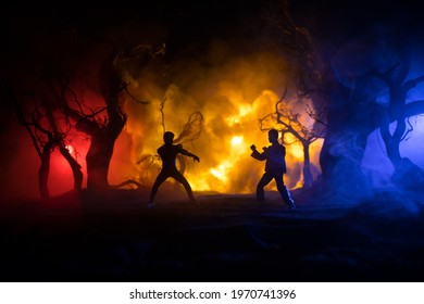 Karate athletes night fighting scene at burning forest. Character karate. Posing figure artwork decoration. Sport concept. Decorated foggy background with light. Selective focus - Shutterstock ID 1970741396