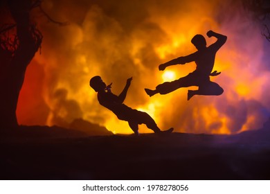 Karate athletes night fighting scene at burning forest. Character karate. Posing figure artwork decoration. Sport concept. Decorated foggy background with light. Selective focus - Shutterstock ID 1978278056