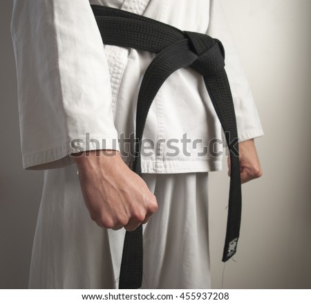 Karate fighter is ready position facing the right side.