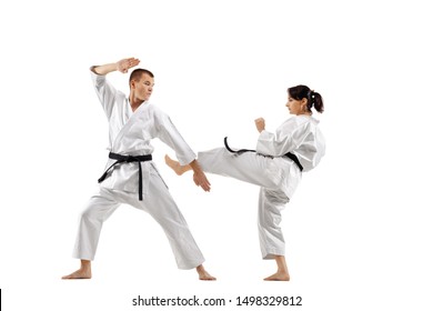 karate girl and boy fighting against white background - Powered by Shutterstock