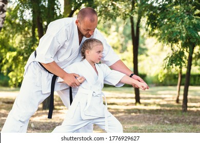 Karate Instructor, Sensei Teaches A Child A Girl Martial Arts