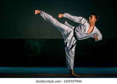 Karate Man With Black Belt Posing, Champion Of The World On Black Background Studio Shot