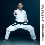 Karate, master and angry portrait of man in studio, black background or practice martial arts. Shouting, fight and person with self defence skill, technique or mma sport contest in action with hands