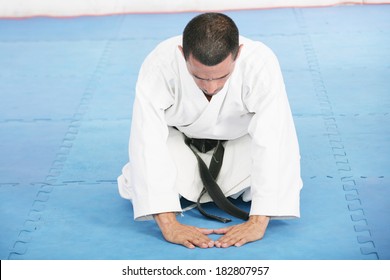 Karate Sensei Demonstrating Bowing In Ceremony