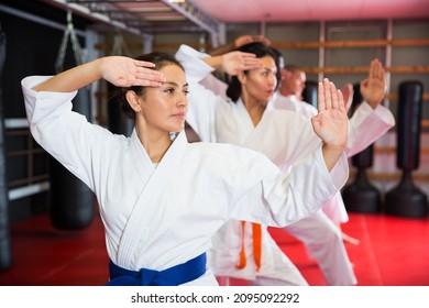 Karate Or Taekwondo Training - Athletes In Kimono Stand In A Fighting Stance