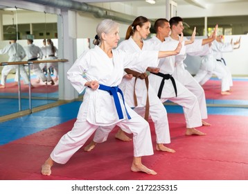 Karate or taekwondo training - athletes in kimono stand in a fighting stance